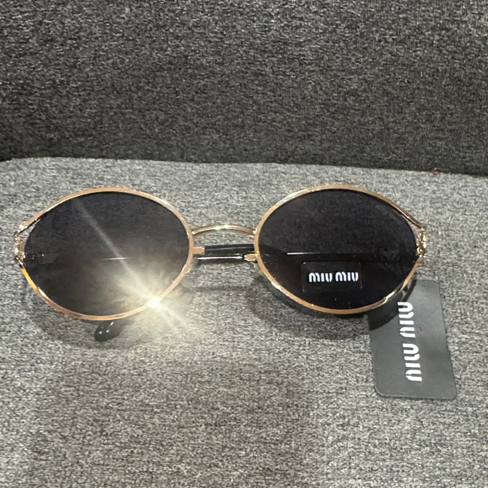 Miu Miu Elegant Black and Gold Sunglasses